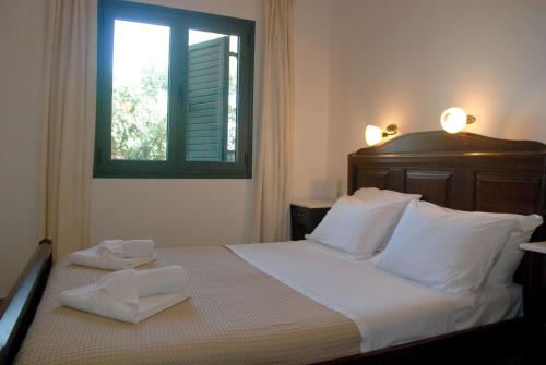 a bedroom with a bed with two towels on it at Eleni Apts in Kamilari