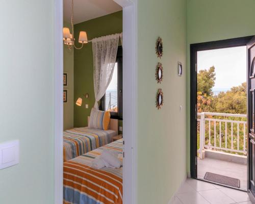a bedroom with two beds and a balcony at Agapitos Apartments in Nikiti