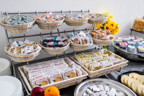a display of pastries and other food items in baskets at HOTEL CONDOR in Rimini
