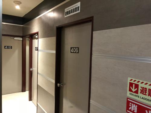 a elevator door with the number on the wall at Business Stay in Satsumasendai
