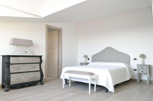 a white bedroom with a white bed and a dresser at B&B Cloud in Santa Maria Capua Vetere