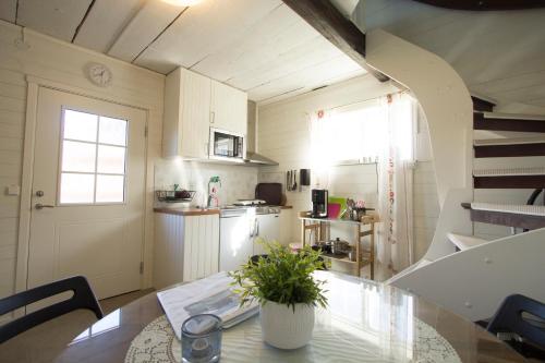 a kitchen with a table with a plant on it at Prinsgården B&B rum stugor in Mora