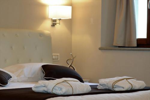 a bed with two towels sitting on top of it at Borgo di Villa Cellaia Resort & SPA in Dicomano