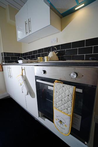a kitchen with a stove with a towel on the oven at The Winter Garden Suites in Blackpool