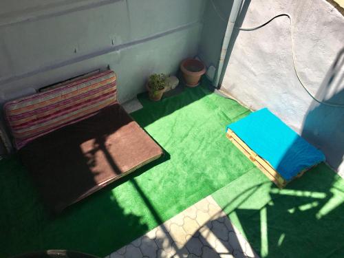 an overhead view of a bench and a blue book at Old Tbilisi Apartments in Tbilisi City