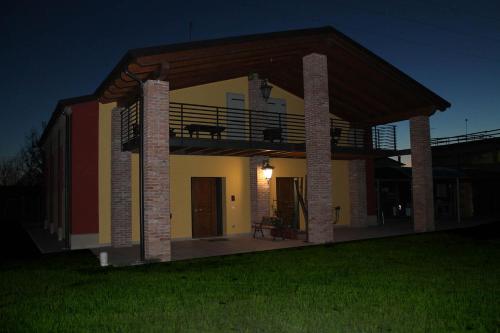 a house with a balcony and a deck at Corte Nuova B&B in Bagnolo San Vito