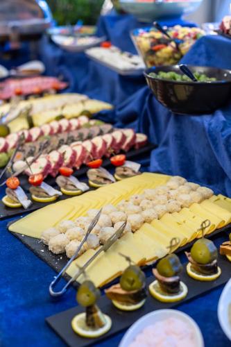 a table topped with plates of food with meat and vegetables at Rizzo Boutique Hotel in Poiana Brasov
