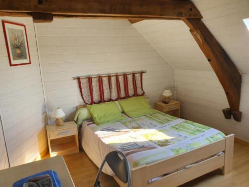 a bedroom with a bed with green pillows at La Ferme de Genarville in Bouville