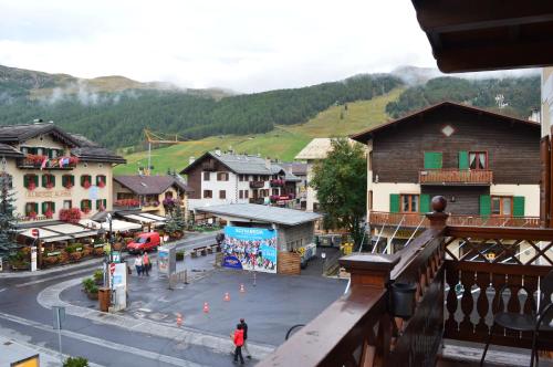 a town in the mountains with a street and people walking at Hotel Compagnoni in Livigno