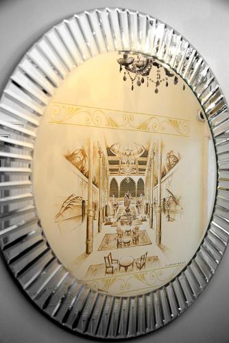 a mirror with a picture of a room with a piano at The Winter Garden Suites in Blackpool