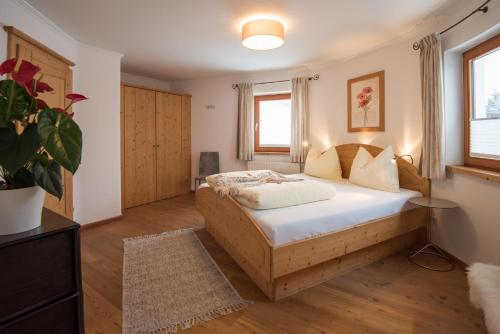a bedroom with a bed and a potted plant at Landhaus Trinker in Schladming