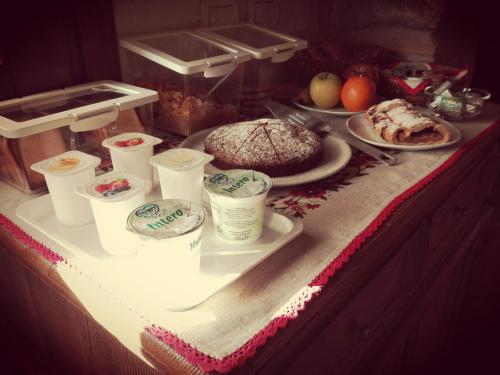 a table with a cake and other food on it at Casa della Fornace in San Vito al Torre