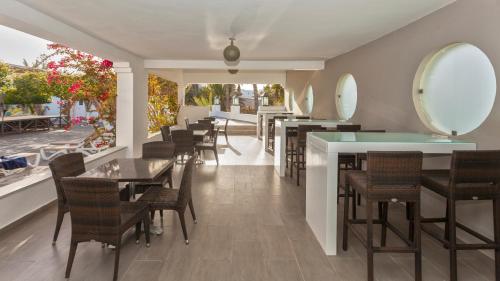 a restaurant with tables and chairs and mirrors on the wall at Djerba Aqua Resort in Midoun