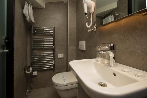a bathroom with a sink and a toilet at BOUTIQUE 25h by Eva stay 018 in Niš