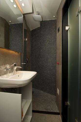 a bathroom with a sink and a shower at BOUTIQUE 25h by Eva stay 018 in Niš