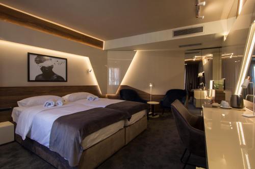 a hotel room with a bed with two eyeballs on it at BOUTIQUE 25h by Eva stay 018 in Niš