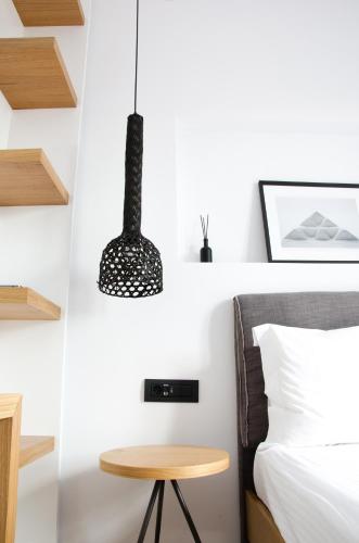 a bedroom with a bed and a table at Eleana Hotel in Tinos Town