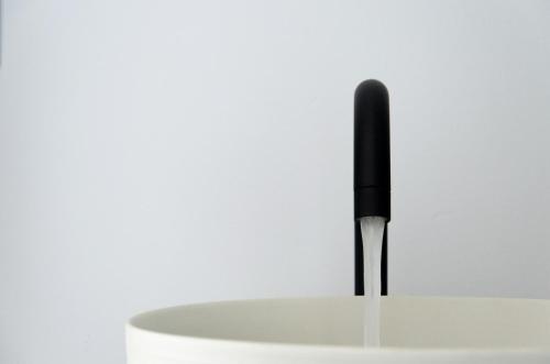 a black pen sticking out of a white cup at Eleana Hotel in Tinos Town