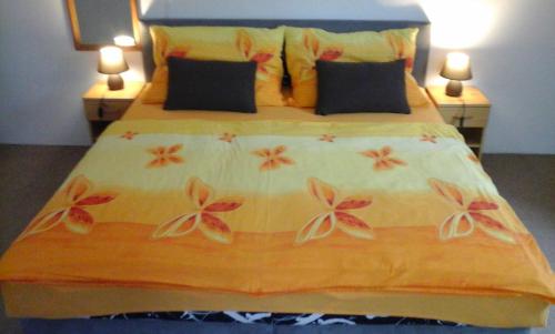a bedroom with a large bed with flowers on it at Modrý Dům in Horní Maršov