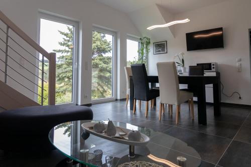 a living room with a dining room table and chairs at FeWo Marita in Wimbach