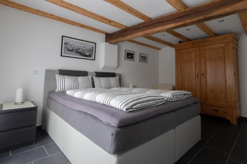 a large bed in a room with a wooden ceiling at FeWo Marita in Wimbach
