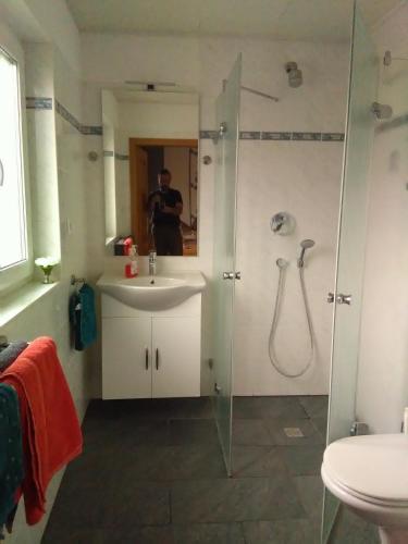 a bathroom with a sink and a shower at Gästehaus Kleine Lana in Obersuhl