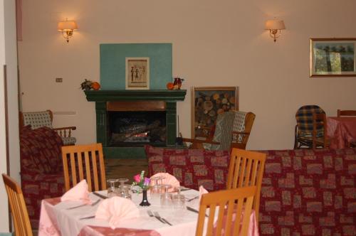 a dining room with a table and a fireplace at hotel lo sciatore in Cotronei