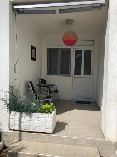 a patio with a potted plant and a red light at Apartments Mia Patria in Ulcinj