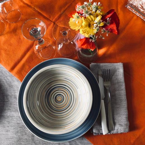a plate on a table with a table cloth with flowers at B&B Terre dì Montecoco in San Pancrazio Salentino