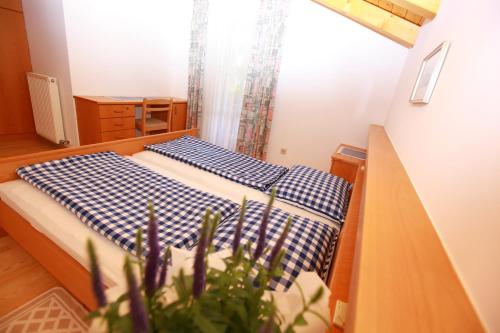a bedroom with two beds and a plant at Fixlhof in Rifiano