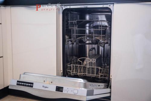 a dishwasher with a machine inside of it at Comfort Apartment Oldenburg in Oldenburg
