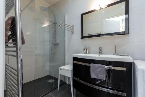 une salle de bain avec un lavabo et une douche dans l'établissement Le St Honoré, à Cannes