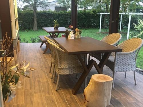 a wooden table and chairs on a patio at Yosemite Homestay in Yuanshan
