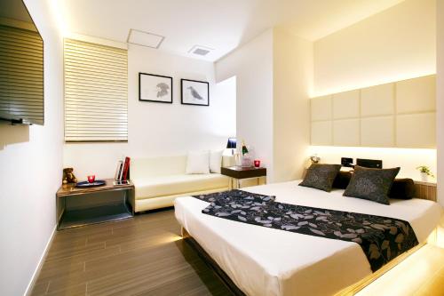 Postel nebo postele na pokoji v ubytování Hotel DUO kinsicho