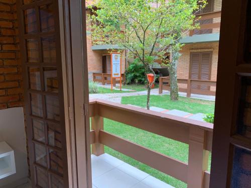 an open door to a balcony with a yard at Hotel São Sebastião da Praia in Florianópolis