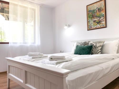 1 cama blanca grande en una habitación con ventana en Wildwood Villa en Apriltsi