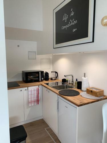 une cuisine avec un évier et un micro-ondes dans l'établissement Péniche 
