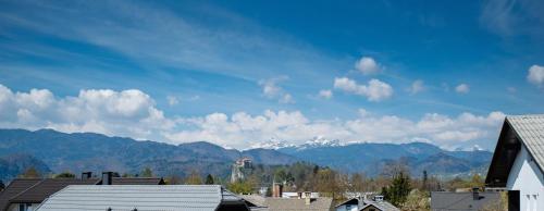 a view of snow capped mountains in the distance at Hotel GH Kolinska in Bled