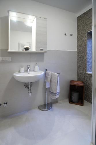 a bathroom with a sink and a mirror and towels at Da nonno in Pezze di Greco