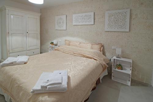 a bedroom with a large bed with towels on it at Da nonno in Pezze di Greco
