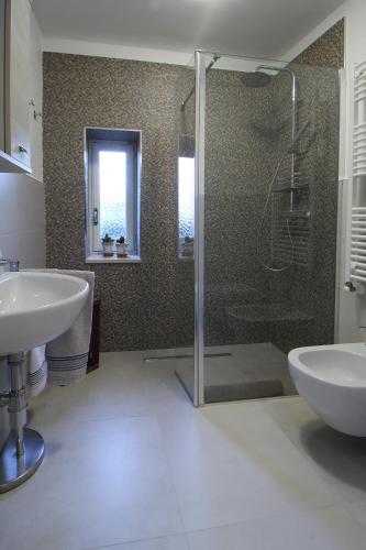 a bathroom with a shower and a sink and a tub at Da nonno in Pezze di Greco
