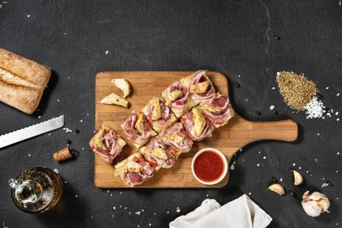 a cutting board with a piece of meat on it at Alloggi The Towers in Montebello Vicentino