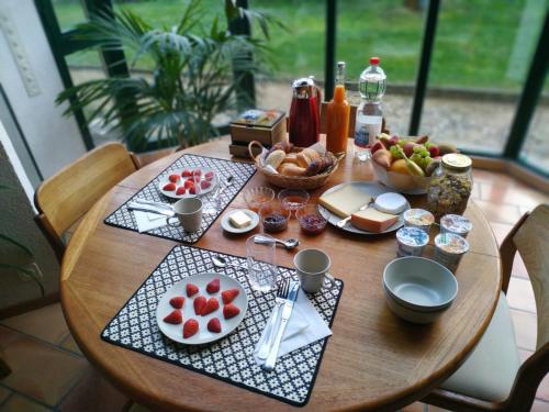 a wooden table with food on top of it at Guest House La Sereine in Romanel-sur-Lausanne