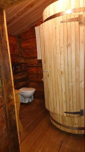 a bathroom with a toilet in a log cabin at Les Cabanes Du Saleve in Collonges-sous-Salève