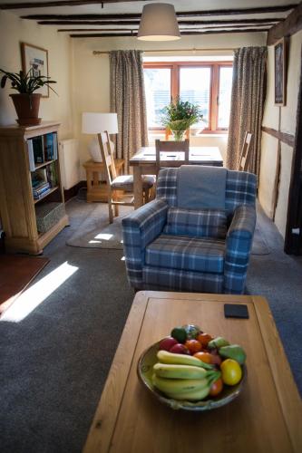 a bowl of fruit on a table in a living room at Number 22, Castle Street in Hay-on-Wye