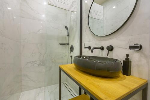 a bathroom with a sink and a shower at Siesta Ragusa in Dubrovnik