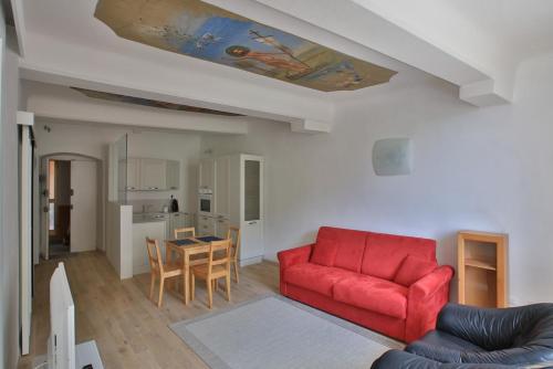 a living room with a red couch and a table at Residenza Sant’ Antonio in Riomaggiore