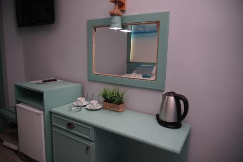 a bathroom with a vanity with a mirror and a sink at Blue Palace Apart Hotel in Marmaris