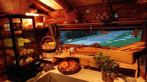 a room with a large television and a table with a table sidx sidx at Les Cabanes Du Saleve in Collonges-sous-Salève