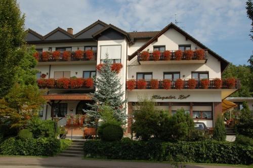 a large building with flowers on the balconies of it at Hotel Riegeler Hof in Riegel